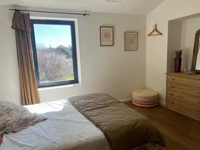 a bedroom with a bed and a window at Grande Villa dans le Parc du Luberon in Beaumont-de-Pertuis