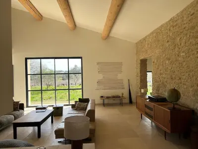 a living room with a couch and a table at Grande Villa dans le Parc du Luberon in Beaumont-de-Pertuis