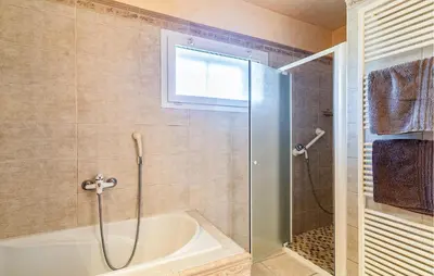 a bathroom with a shower and a bath tub at 2 Bedroom Amazing Home In Noves in Noves