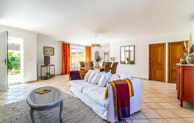 a living room with a white couch and a table at 2 Bedroom Amazing Home In Noves in Noves