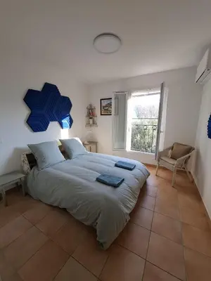 a bedroom with a large bed and a window at Villa Nicole avec piscine & jardin privés, parking dans le cœur du Luberon, proche Gordes, Roussillon, Goult, Bonnieux in Oppède