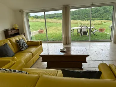 a living room with a yellow couch and a table at Gite le pèlerin in Sault-de-Vaucluse