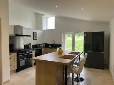 a kitchen with a wooden table and a counter top at Gite le pèlerin in Sault-de-Vaucluse