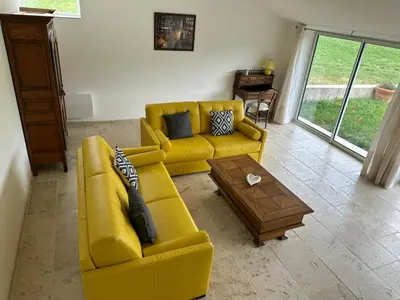 a living room with a yellow couch and a coffee table at Gite le pèlerin in Sault-de-Vaucluse