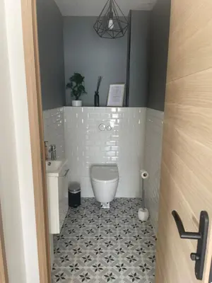 a bathroom with a toilet and a sink at Villa Noyau & Pépin in Rognes