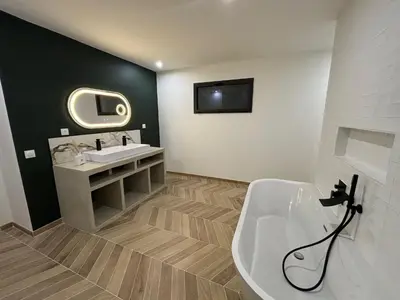 a bathroom with a white sink and a mirror at Villa Noyau & Pépin in Rognes
