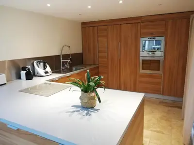 a kitchen with a white counter top and wooden cabinets at country house in Provence in Pierrevert
