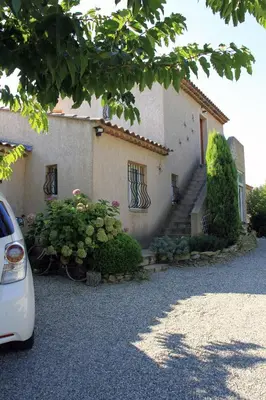 a white car parked in front of a building at Appartement les Balcons d'Azur in Vernègues
