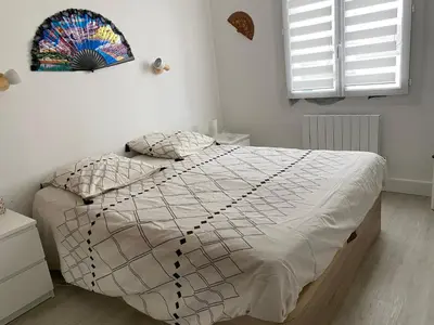 a white bathroom with a sink and a mirror at Grand appartement spacieux in Sénas