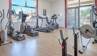 a gym with several exercise bikes and elliptical machines at Maison aux Demeures du Ventoux in Aubignan