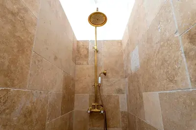 a shower with a shower head in a bathroom at L’oustaou de Ventabren Village Square in Ventabren