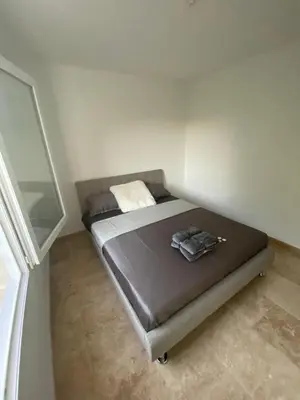 a small bedroom with a bed in the corner at La Maison Myssa in Apt