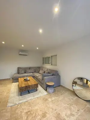 a living room with a couch and a table at La Maison Myssa in Apt