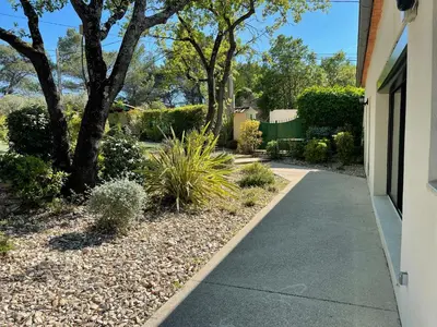 a sidewalk next to a house with trees and plants at Maison Cireline en Provence, Rognes in Rognes