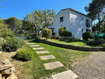 a stone path leading to a white building at Maison Cireline en Provence, Rognes in Rognes