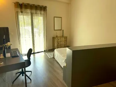 a bedroom with a bed and a desk with a computer at Maison Cireline en Provence, Rognes in Rognes