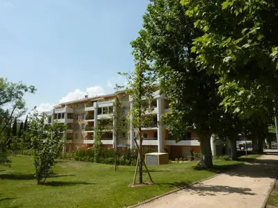 a large building with trees in front of it at Appartement calme et spacieux à Aix en Provence in Aix-en-Provence
