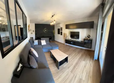 a living room with a couch and a table at Appartement calme et spacieux à Aix en Provence in Aix-en-Provence