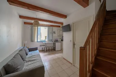 a living room with a couch and a staircase at Apparemment hypercentre Aix-en-Provence in Aix-en-Provence