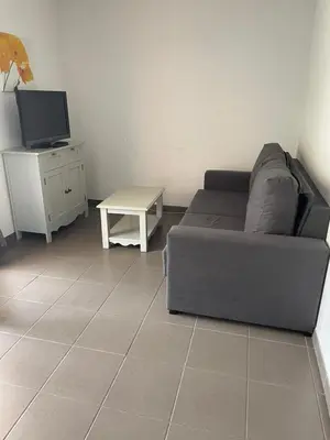 a living room with a couch and a table at Maison aux Demeures du Ventoux Adaptée PMR in Aubignan