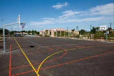 an empty basketball court with a basketball hoop at Maison aux Demeures du Ventoux Adaptée PMR in Aubignan