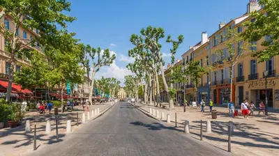 an empty street in a city with buildings at T2 charmant avec mezzanine au cœur d'Aix in Aix-en-Provence