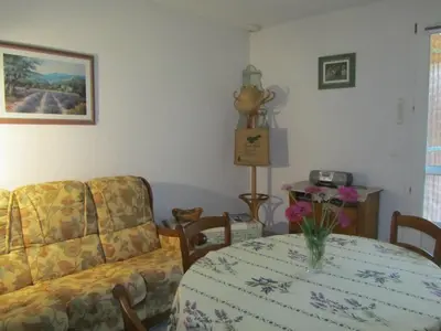 a living room with a couch and a table at Maison en PROVENCE in Robion en Luberon