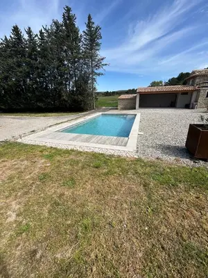 a swimming pool in front of a house at Charmante maison avec piscine et grand jardin in LʼIsle-sur-la-Sorgue