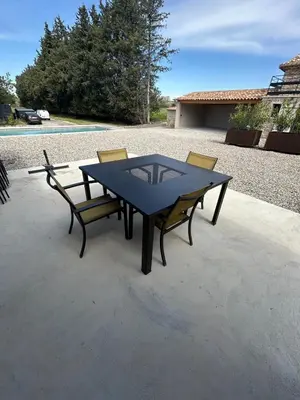 a table and chairs sitting on a patio at Charmante maison avec piscine et grand jardin in LʼIsle-sur-la-Sorgue