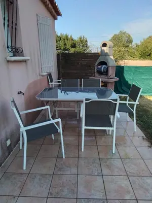 a patio with a table and chairs and a stove at Ventoux beautiful quiet house in Saint-Christol