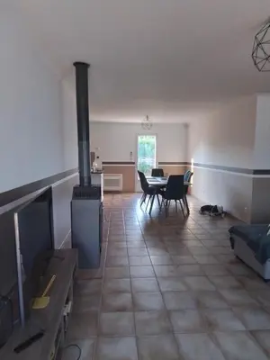 a living room with a stove and a table and chairs at Ventoux beautiful quiet house in Saint-Christol