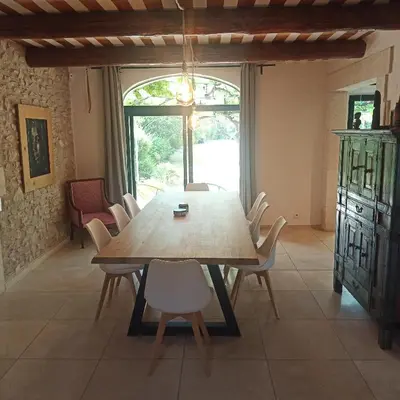 a dining room with a wooden table and chairs at Charming house Saint Remy de Provence in Saint-Rémy-de-Provence