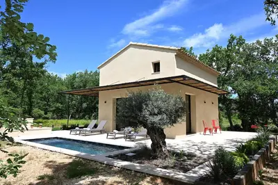 a house with a pool in front of it at Le Mazet de la Truffière in Gordes