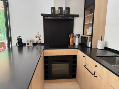 a kitchen with a black counter top with a stove at Le Mazet de la Truffière in Gordes