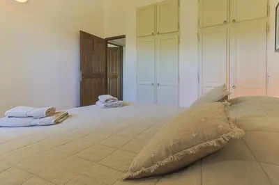 a large bed with a pillow on top of it at Villa Vue Luberon in Gordes