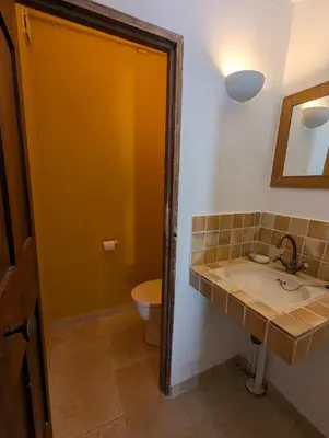 a bathroom with a sink and a toilet at Mas traditionnel à Gordes en pleine nature in Gordes
