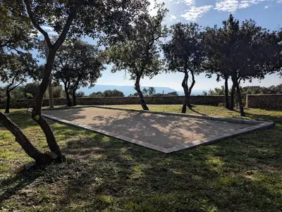 a metal ramp in the middle of a field with trees at Mas traditionnel à Gordes en pleine nature in Gordes