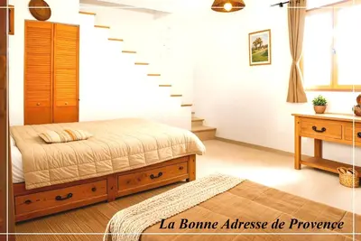 a bedroom with a bed and a staircase at La Bonne Adresse - Gite ZENITUDE in Cornillon-Confoux