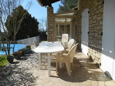 a white table and chairs on a patio at Villa Provençale avec piscine in Pernes-les-Fontaines