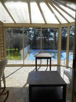 a pavilion with a table and a pool outside at Villa Provençale avec piscine in Pernes-les-Fontaines