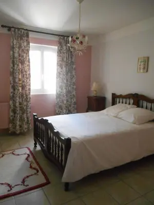 a bedroom with a large bed and a window at Villa Provençale avec piscine in Pernes-les-Fontaines