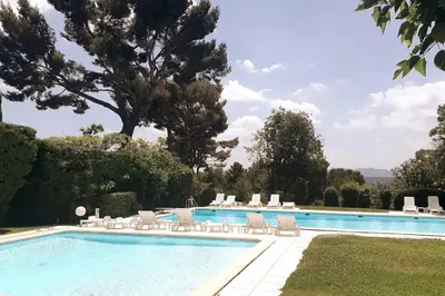 a swimming pool with lounge chairs and a swimming pool at Appartement Aix, résidence calme avec piscine in Aix-en-Provence