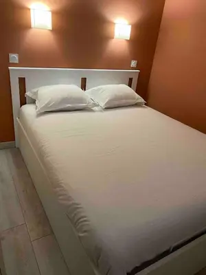 a large white bed with two pillows on it at SUNRISE - Golf de Pont Royal in Mallemort