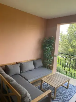 a couch and a table in a room with a window at SUNRISE - Golf de Pont Royal in Mallemort