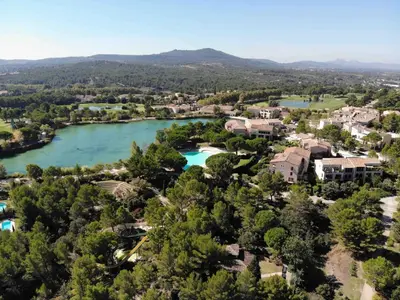 an aerial view of a resort with a river at SUNRISE - Golf de Pont Royal in Mallemort