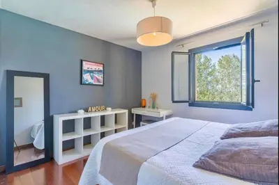 a bedroom with a large bed and a window at Villa Aix-en-Provence Pool and absolute calm in Aix-en-Provence