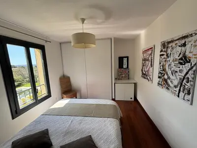 a bedroom with a bed and a large window at Villa Aix-en-Provence Pool and absolute calm in Aix-en-Provence