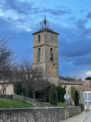 an old tower with a clock on top of it at Room in Medieval Cereste in Céreste