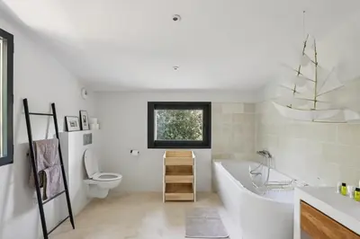a bathroom with a tub and a toilet and a sink at Big Modern Villa Ste Victoire 10min CityCenter Aix in Saint-Marc-Jaumegarde