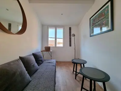 a living room with a couch and two tables at Appartement climatisation centre historique in Aix-en-Provence
